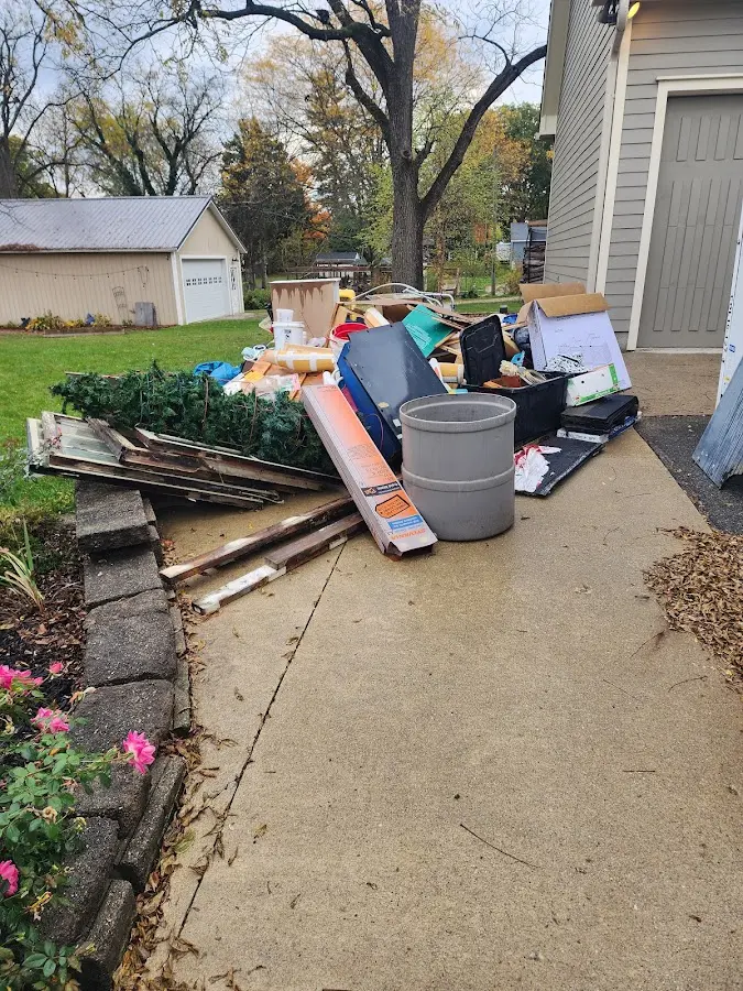 Dumpster being loaded with debris for Estate Cleanout Dumpster Rental in Shorewood Forest